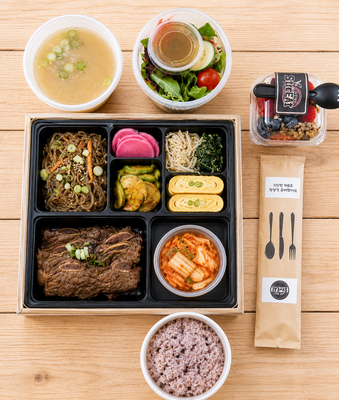 Premium Korean lunch box with LA galbi, multigrain rice, soup, salad and chef's side dishes